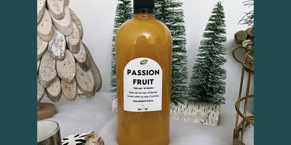 Bottle of passion fruit juice with holiday decorations.