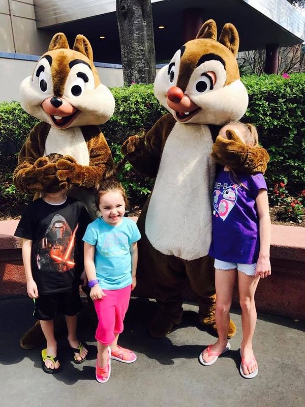 Kids with Chip and Dale with the characters being silly and covering their faces at Hollywood Studio