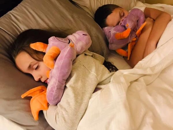 Paul and Evie sleeping with Figment snuggle plushie at our Disney Resort