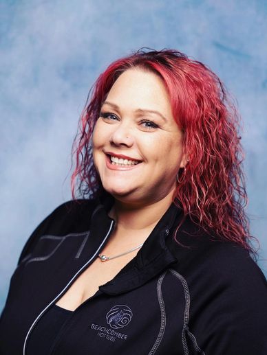 headshot of a woman with dark pink hair
