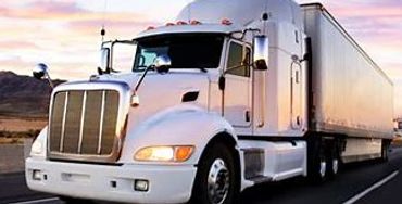 White tractor trailer in the morning sky