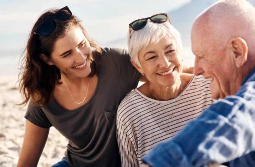 Family spending time together on the beach with aging parents, highlighting the importance of safety