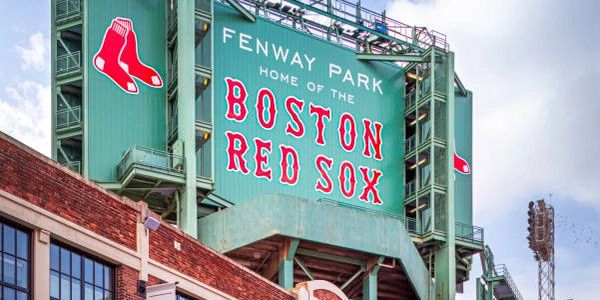 Exterior view of Fenway Park, home of the Boston Red Sox, with its iconic green signage.