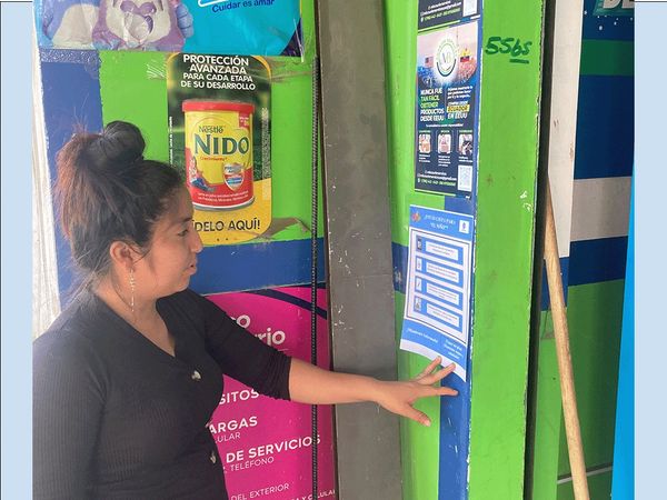 Flier posted at pharmacy is read by a customer.