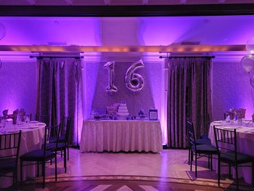 Sweet 16 dessert table with purple uplighting in Greenwich, Connecticut.