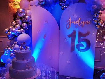 Illuminated by vibrant blue and purple uplighting, emphasizing the attention to detail.