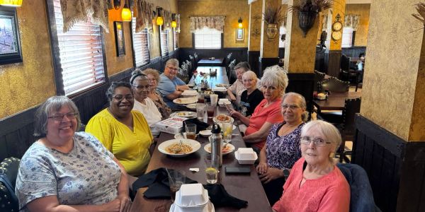 Group of elderly women dining together at a restaurant.