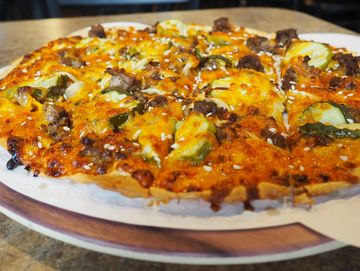 Thousand Island, RRF Ground Beef, Cheddar Cheese, Onion, Pickle & Sesame Seeds.