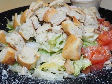 A delicious Caesar Salad with croutons and parmesan cheese.