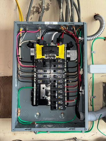Open electrical breaker panel with organized wiring and multiple circuit breakers.