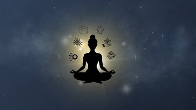 Silhouette of a person meditating with spiritual symbols glowing around.