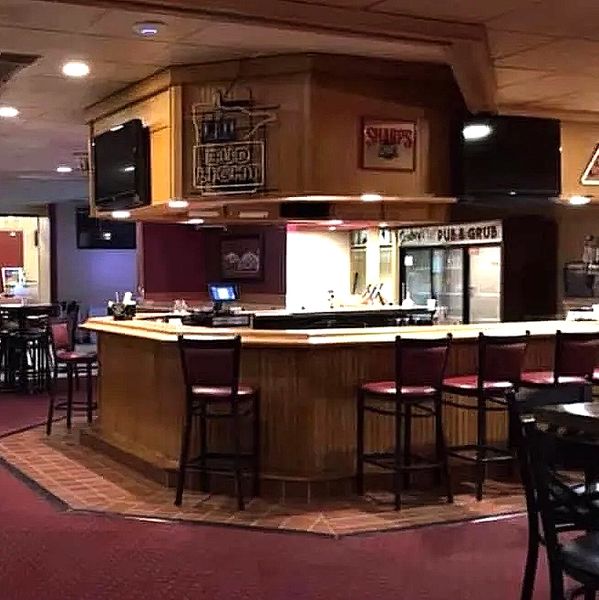 Scobey's bar with chairs and signage.