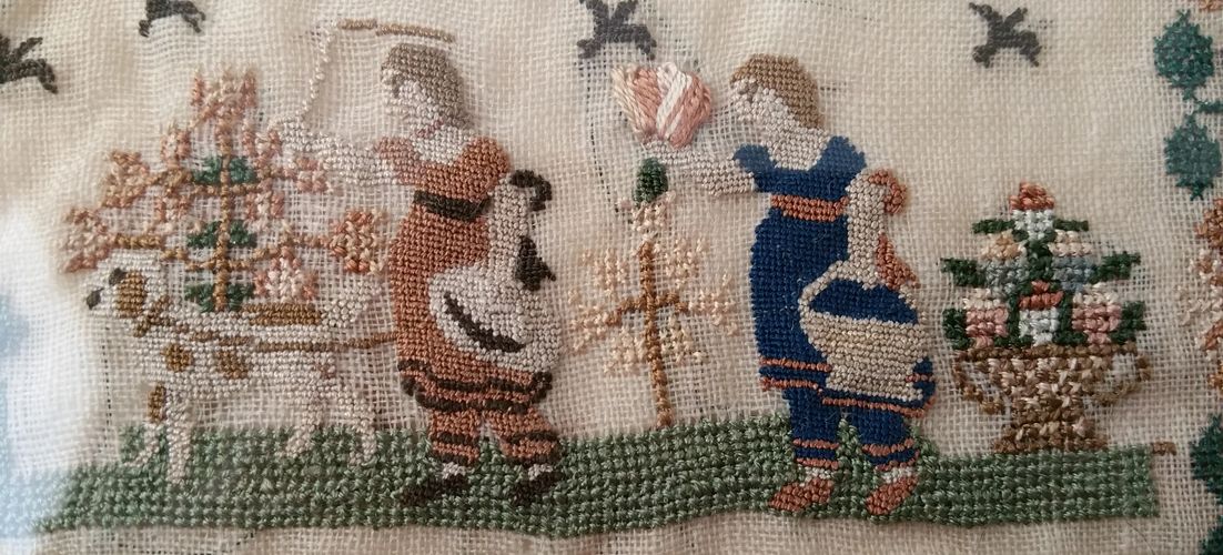 Cross stitch and petit point on an early 1800s sampler. Silk on linen.