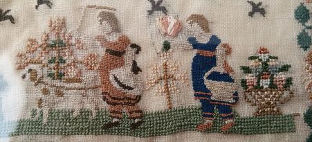 Cross stitch and petit point on an early 1800s sampler. Silk on linen.