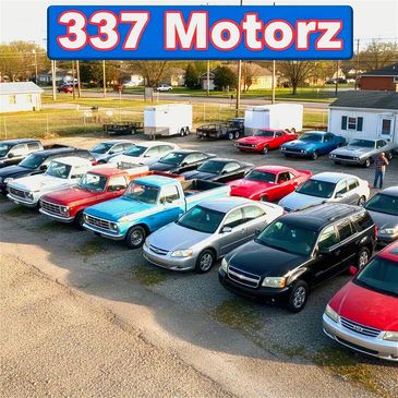 A variety of cars and trucks parked outside 337 Motorz dealership.