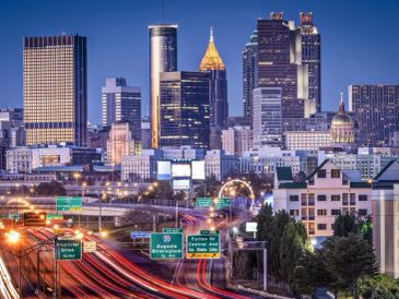 Night view of a city skyline with highways.