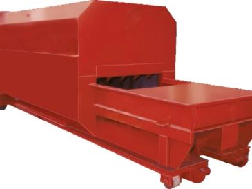 Large red industrial machine on wheels.