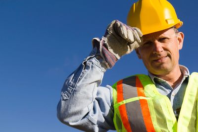 Construction worker in hard hat and safety vest.