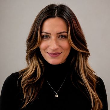 Woman with long brown hair and a subtle smile.