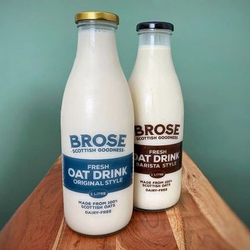 Two glass bottles of Brose brand fresh oat drink.