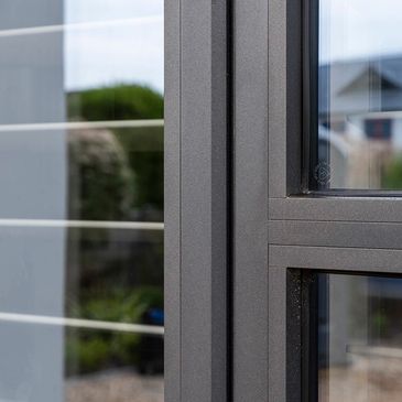 Close-up of a modern window frame with glass panes.