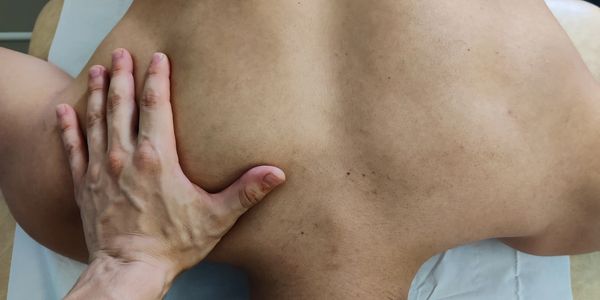 A helping hand on a back during a sports massage in our Central London clinic
