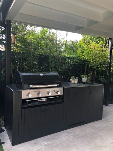 Custom BBQ area with BBQ and cabinetry and outdoor sink and hidden fridge