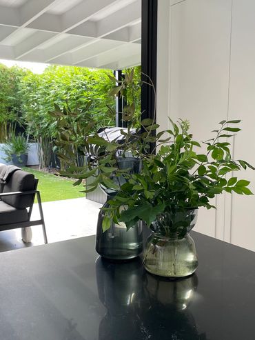 Kitchen island with floral arrangement looking onto garden
