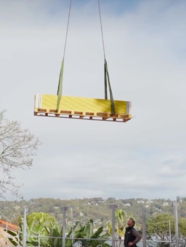Crane delivering materials to a difficult site in Newport