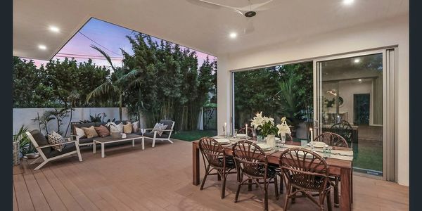 Outdoor large covered patio with dining and seating areas, light and fan