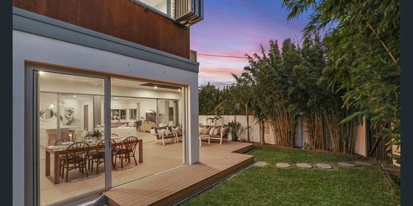 Open plan living area to back garden with dining, decking and large sliding doors