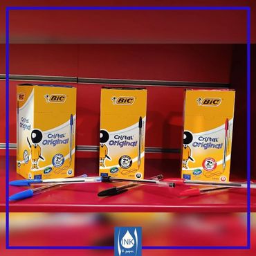 Three boxes of Bic Cristal Original pens with scattered blue, black, and red pens.