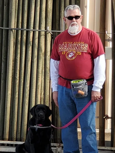 An older man with his service dog.