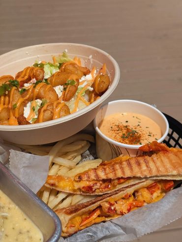 Shrimp salad, fries, lobster grilled sandwich, and creamy soup meal.
