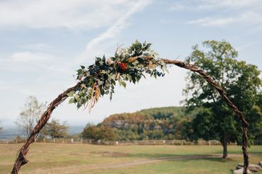 Rustic wedding arbor with wood flowers and greenery for a romantic ceremony backdrop
