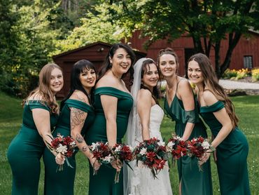 bridal and bridesmaid bouquets with tiger lilies, succulents, and white sola wood flowers