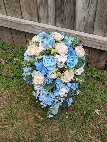 cascading bridal bouquet with white roses and blue roses and hydrangeas