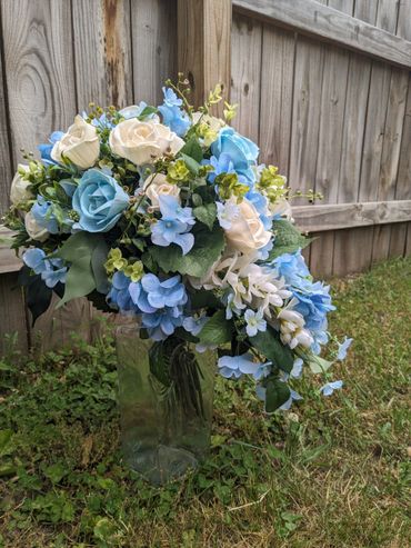 cascading bridal bouquet with white roses and blue roses and hydrangeas