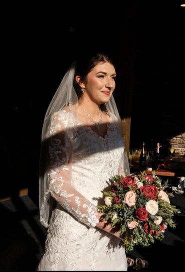 burgundy roses and pink roses and white roses in a garden style bouquet with italian ruscus
