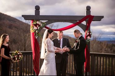 Elegant wedding arch with cascading wood flowers for a timeless, eco-friendly look
