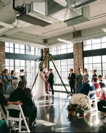 Handcrafted wood flower arbor with natural textures for a rustic wedding ceremony