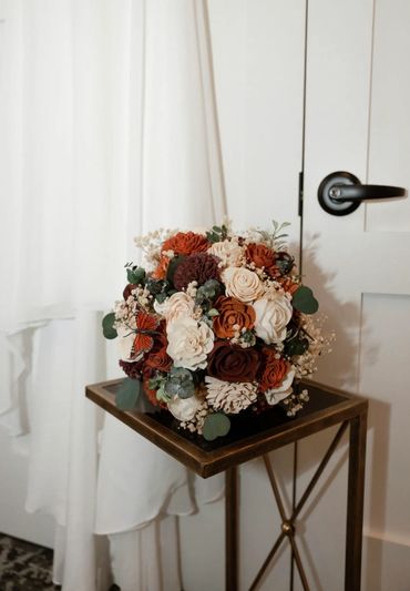 bridal bouquet with wood flower dahlias, roses, and babys breath