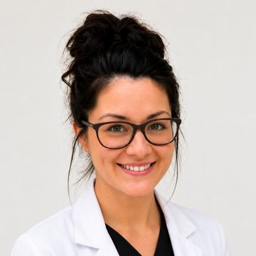 Smiling female medical professional wearing glasses and a white lab coat.