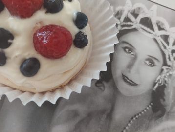 A generous Swiss meringue, topped with a swirl of whipped cream and a mix of fresh berries.
A very l