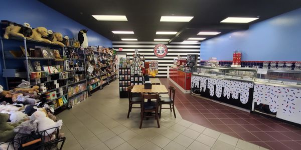 The interior of Cops & Robbers Birch Run. A gift area on the left. A ice cream counter on the right.