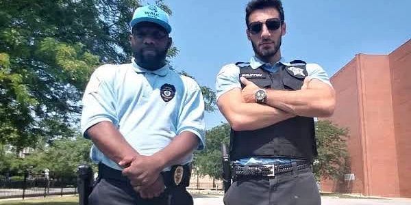 Two security officers posing outside.