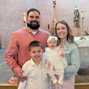 Family posing inside a church for a special occasion.