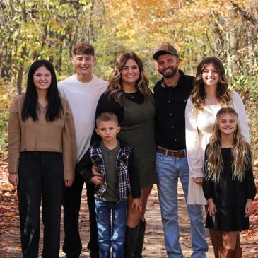 A happy family posing outdoors in autumn.