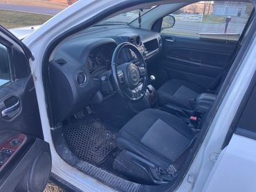 Interior view of a Jeep car showing front seats and dashboard.