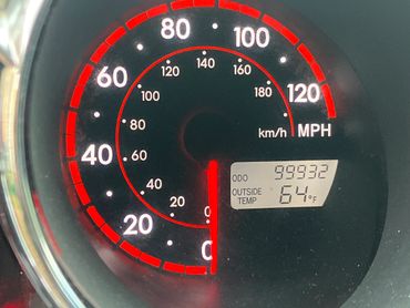 Car speedometer showing 0 MPH and odometer reading 99932 miles.